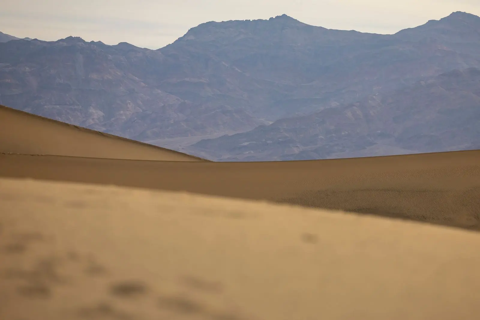 Sand dunes with mountains beyond, the kind of inland day trip from Ras Al Khaimah